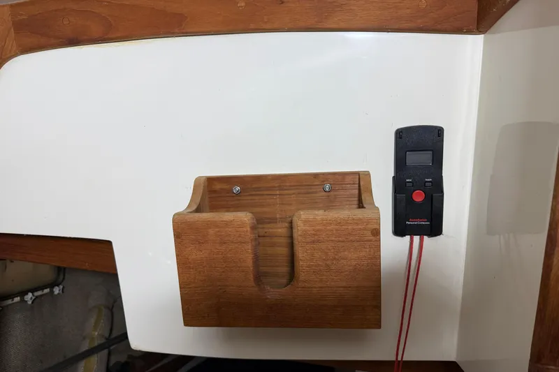 Slide: The Image of Wooden holder and electronic device on 1986 CAL 33 sailboat interior. - 33