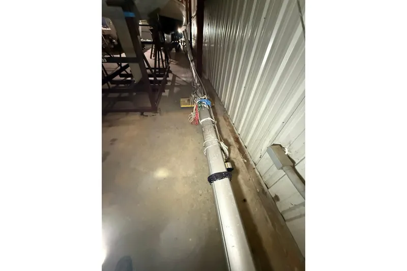 Slide: The Image of Industrial setting with metal pipe alongside a corrugated wall, CAL 33 model, 1986. - 37