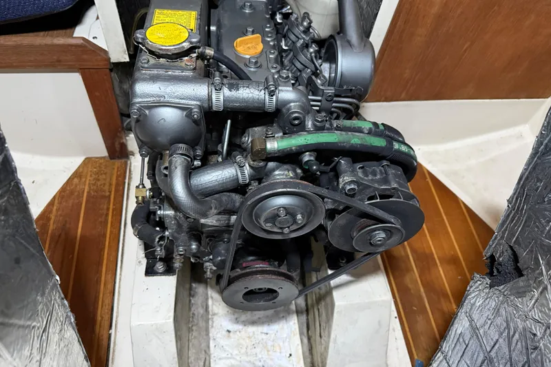 Slide: The Image of 1986 CAL 33 engine compartment with visible mechanical components and belts. - 40