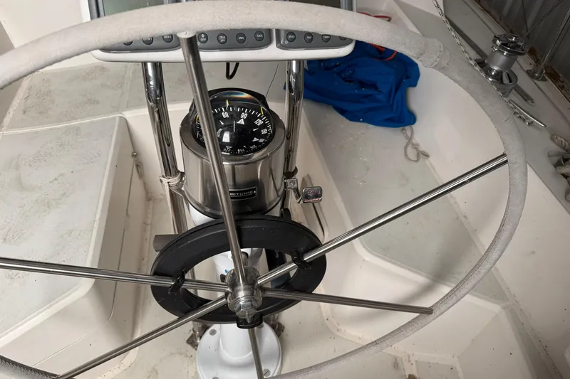 Slide: The Image of Steering wheel and compass on a 1986 CAL 33 sailboat cockpit. - 8