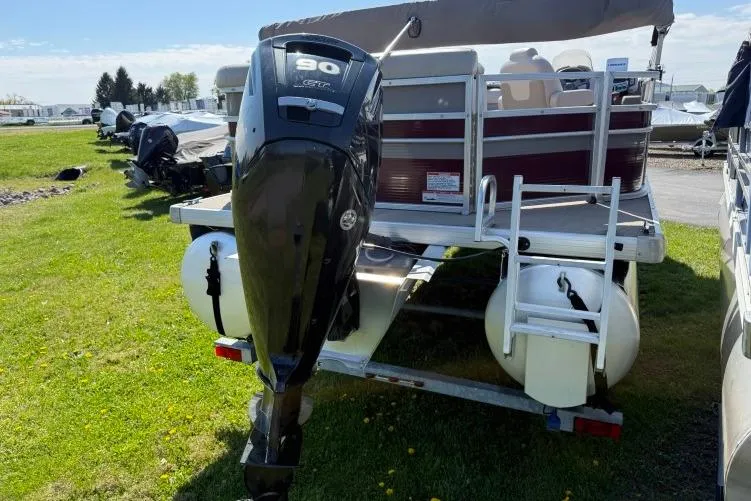 Slide: The Image of 2016 Princecraft Vectra 21 pontoon boat with 90 HP outboard motor, parked on grass. - 2