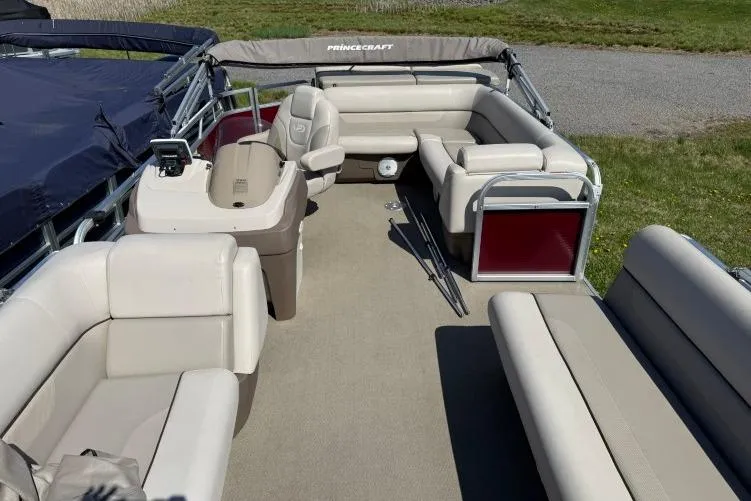 Slide: The Image of 2016 Princecraft Vectra 21 pontoon boat with beige seating and spacious deck layout. - 5