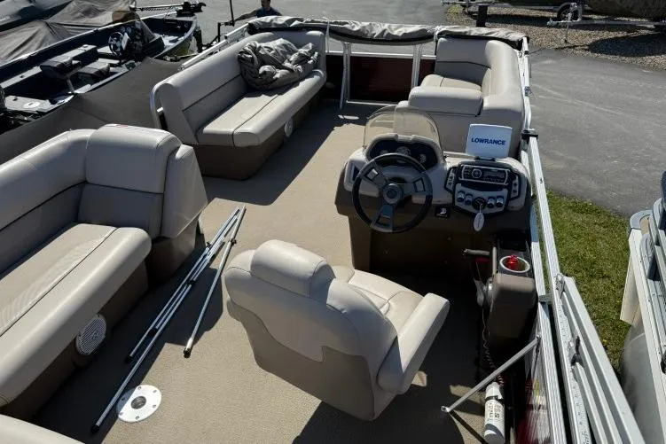 Slide: The Image of 2016 Princecraft Vectra 21 pontoon boat interior with beige seating and steering console. - 6