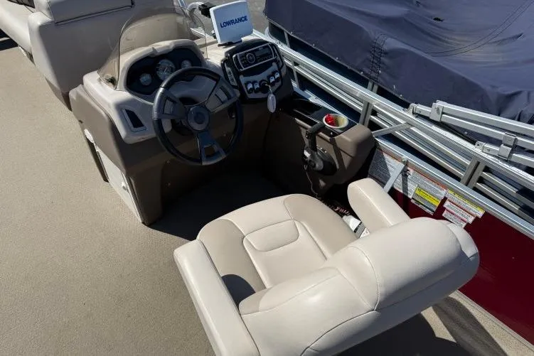 Slide: The Image of 2016 Princecraft Vectra 21 boat cockpit with steering wheel and control panel. - 9