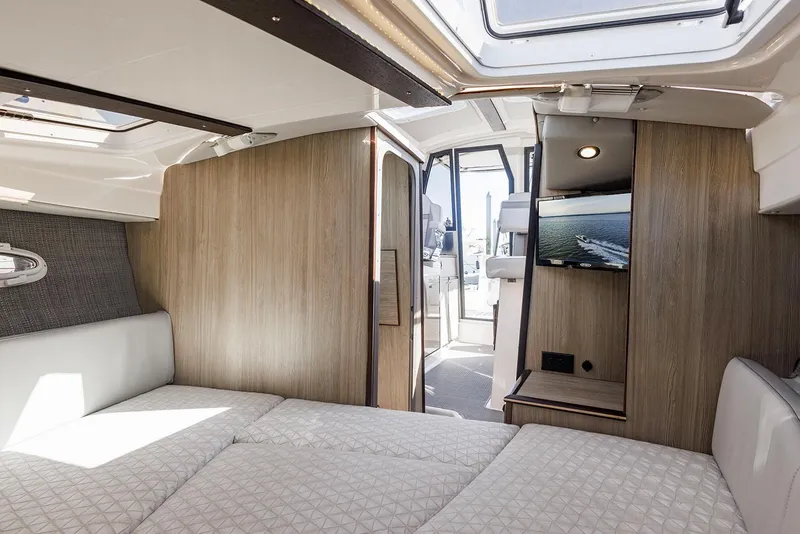 Slide: The Image of Manufacturer Provided Image: Luxurious interior of 2025 Solara S-250 Coupe with modern design and comfortable bedding. - 19