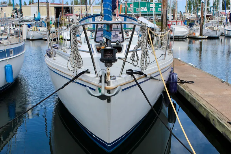 Slide: The Image of 1989 Catalina 36 sailboat docked in a marina, front view. - 1