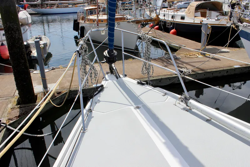 Slide: The Image of Bow of 1989 Catalina 36 sailboat docked at marina with ropes and rigging. - 11