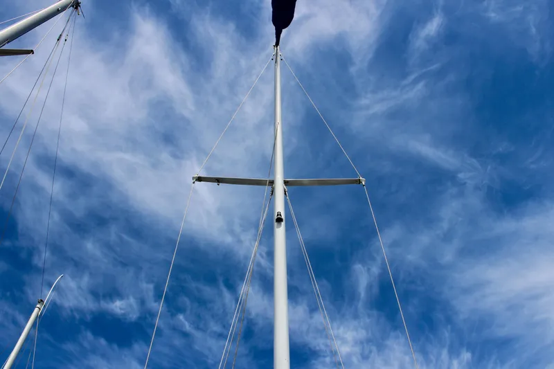 Slide: The Image of Mast of 1989 Catalina 36 sailboat against a blue sky with wispy clouds. - 15