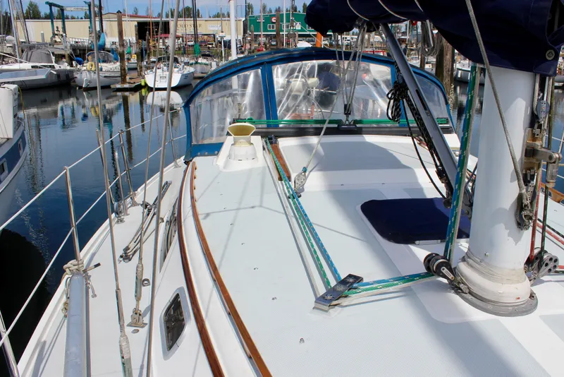 Slide: The Image of 1989 Catalina 36 sailboat deck view at marina, showcasing rigging and cockpit area. - 17