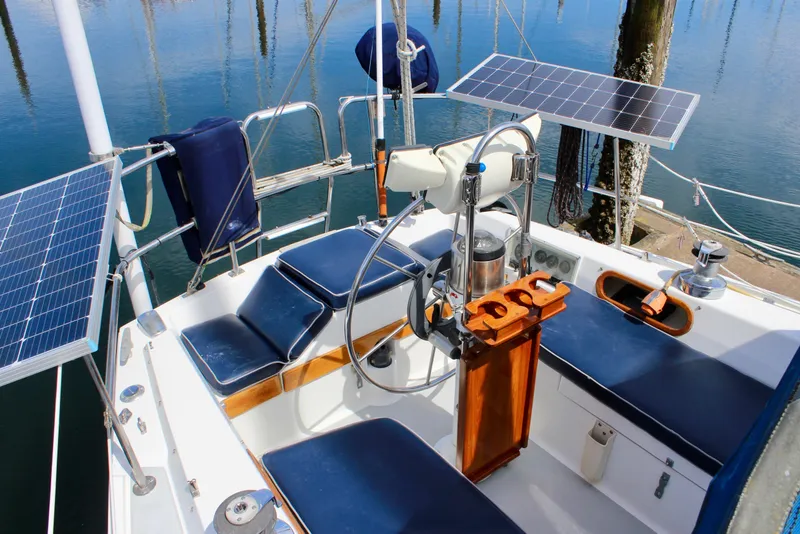 Slide: The Image of Cockpit of 1989 Catalina 36 sailboat with solar panels and blue seating. - 19
