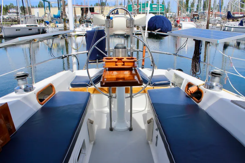Slide: The Image of Cockpit of a 1989 Catalina 36 sailboat with blue seating and wooden accents. - 20