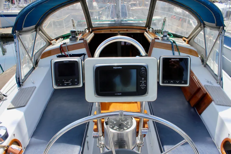 Slide: The Image of Cockpit of a 1989 Catalina 36 sailboat with navigation equipment and steering wheel. - 21