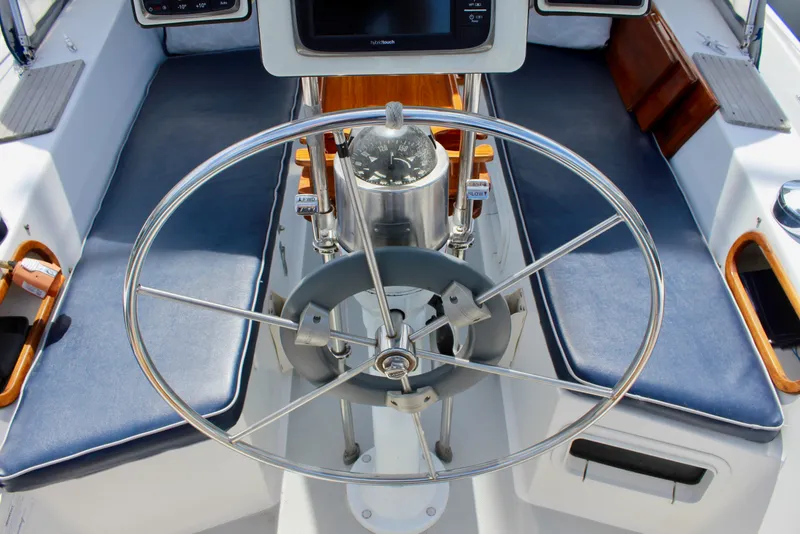 Slide: The Image of Cockpit of 1989 Catalina 36 sailboat with steering wheel and navigation instruments. - 22
