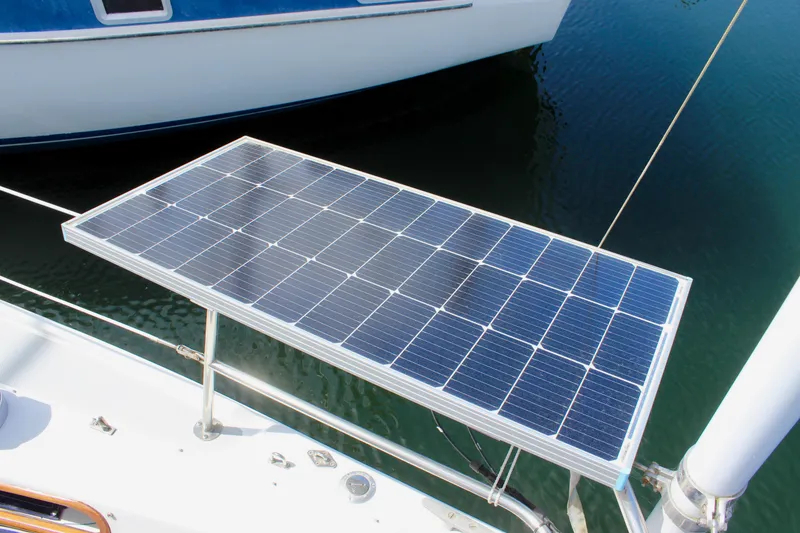 Slide: The Image of Solar panel on a 1989 Catalina 36 sailboat, docked on calm water. - 24