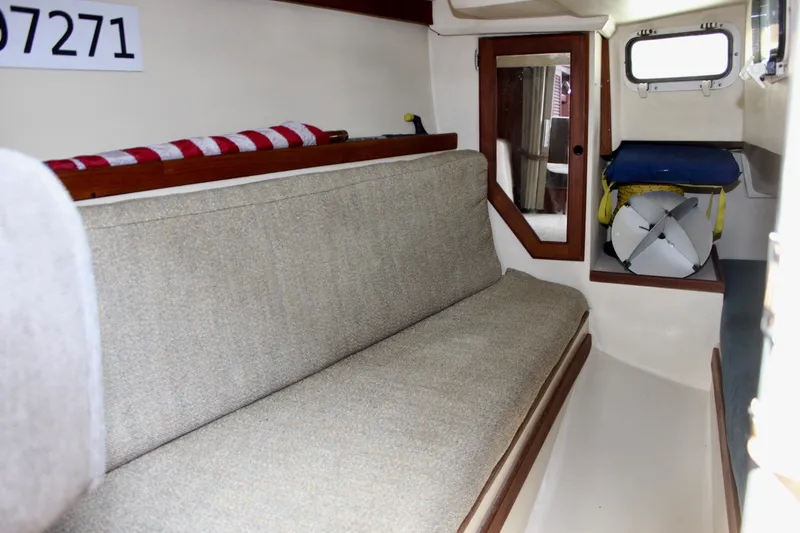 Slide: The Image of Interior of 1989 Catalina 36 sailboat with beige seating and wooden accents. - 36