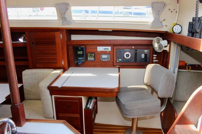 Slide: The Image of Interior of a 1989 Catalina 36 sailboat with navigation station and seating area. - 38