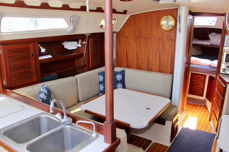 Slide: The Image of Interior of a 1989 Catalina 36 sailboat with cozy seating and wooden cabinetry. - 44