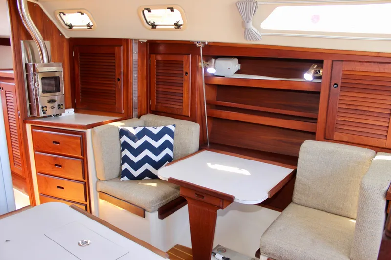 Slide: The Image of Interior of a 1989 Catalina 36 sailboat with cozy seating and wooden cabinetry. - 45