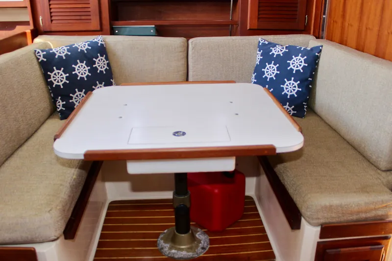 Slide: The Image of Cozy dining area in a 1989 Catalina 36 sailboat with nautical-themed cushions. - 46