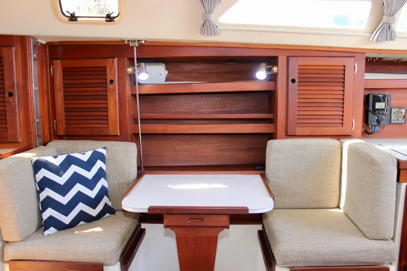 Slide: The Image of Interior of 1989 Catalina 36 sailboat with cozy seating and wooden cabinetry. - 47