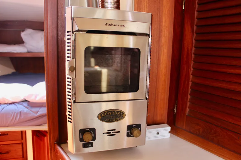 Slide: The Image of Stainless steel heater inside 1989 Catalina 36 yacht cabin with wooden interior. - 48