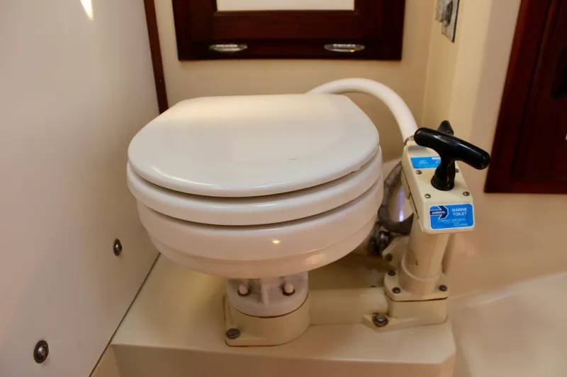 Slide: The Image of Marine toilet in 1989 Catalina 36 yacht bathroom, featuring manual flush system. - 51