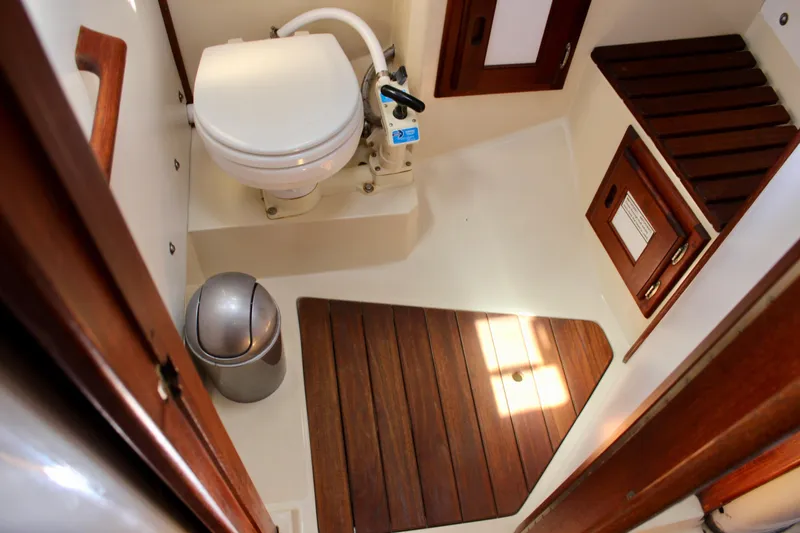 Slide: The Image of 1989 Catalina 36 yacht bathroom with wooden accents and compact design. - 53