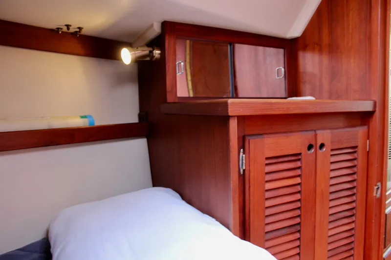 Slide: The Image of Cozy cabin interior of 1989 Catalina 36 sailboat with wooden cabinetry and soft lighting. - 55