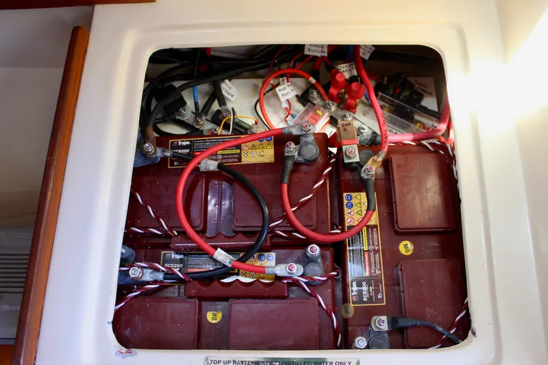 Slide: The Image of Battery compartment of a 1989 Catalina 36 sailboat with connected cables. - 56