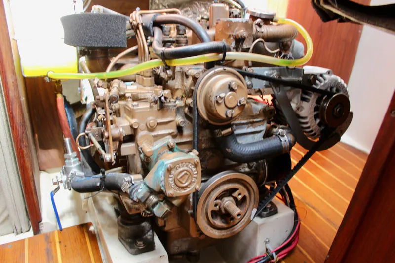 Slide: The Image of Engine of a 1989 Catalina 36 sailboat, showcasing mechanical components and belts. - 60