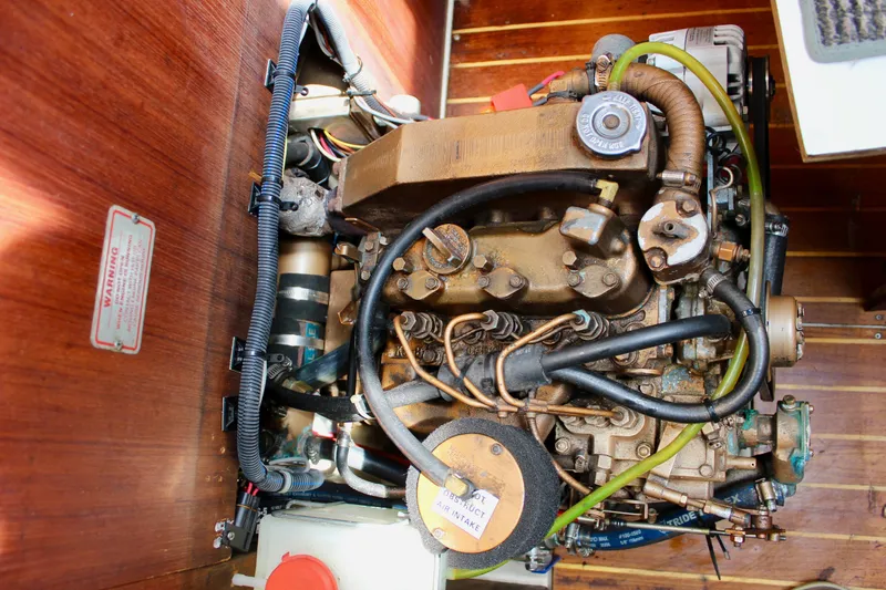 Slide: The Image of Engine compartment of a 1989 Catalina 36 sailboat, showcasing detailed mechanical components. - 61
