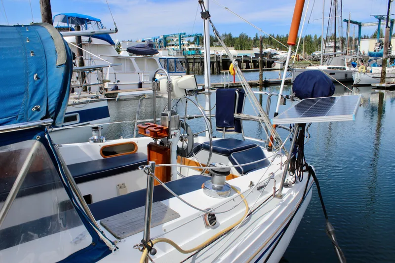 Slide: The Image of 1989 Catalina 36 sailboat docked, featuring solar panel and nautical equipment. - 7