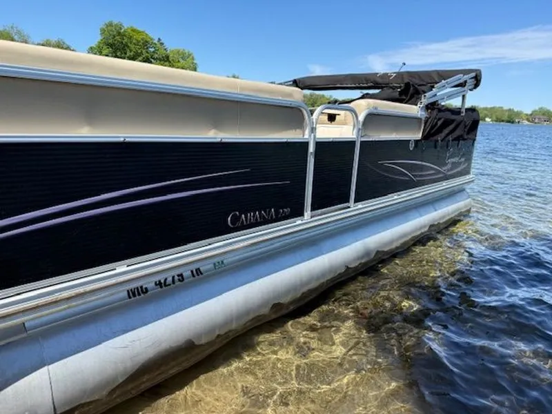 Slide: The Image of 2011 Cypress Cay 220 Cabana pontoon boat by the lakeside. - 1