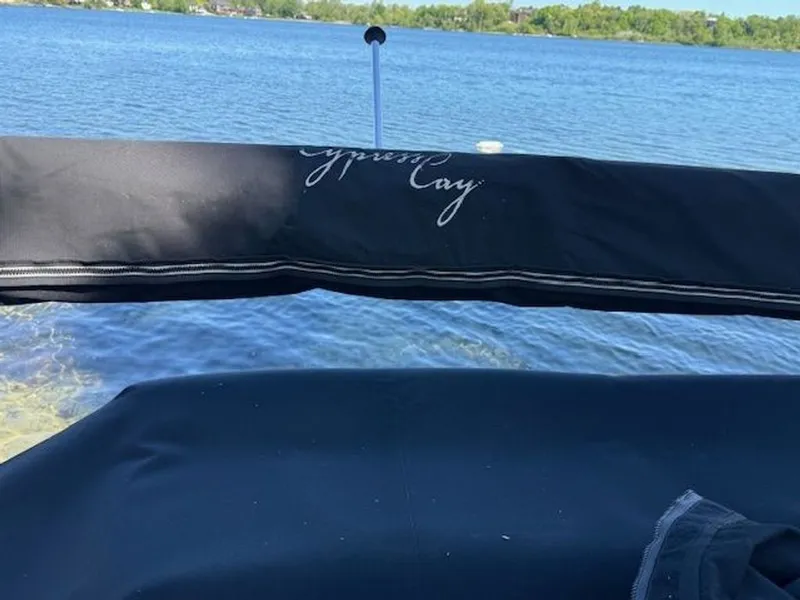 Slide: The Image of Cypress Cay 220 Cabana boat on a serene lake, 2011 model. - 16