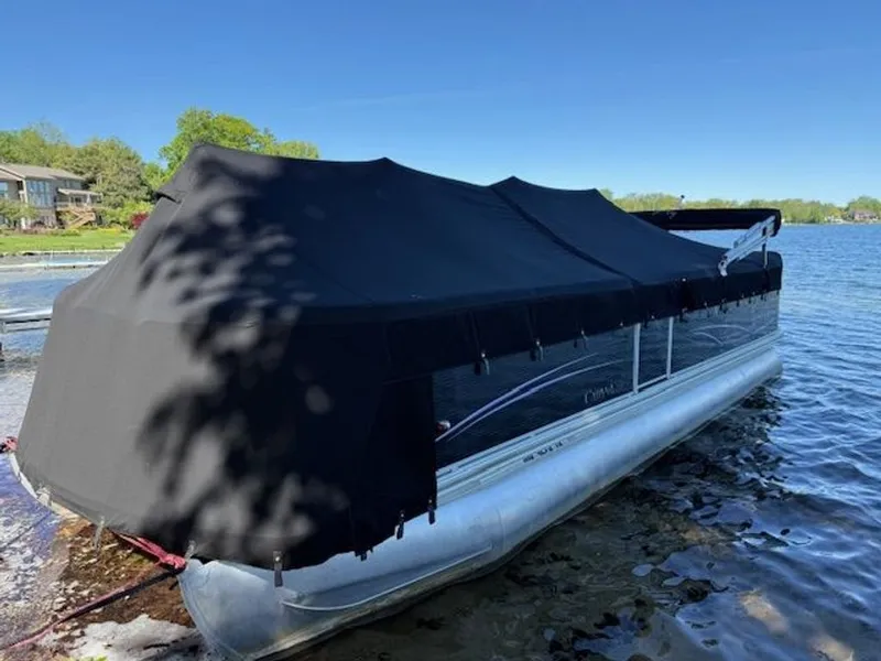 Slide: The Image of 2011 Cypress Cay 220 Cabana pontoon boat with cover on lake. - 17