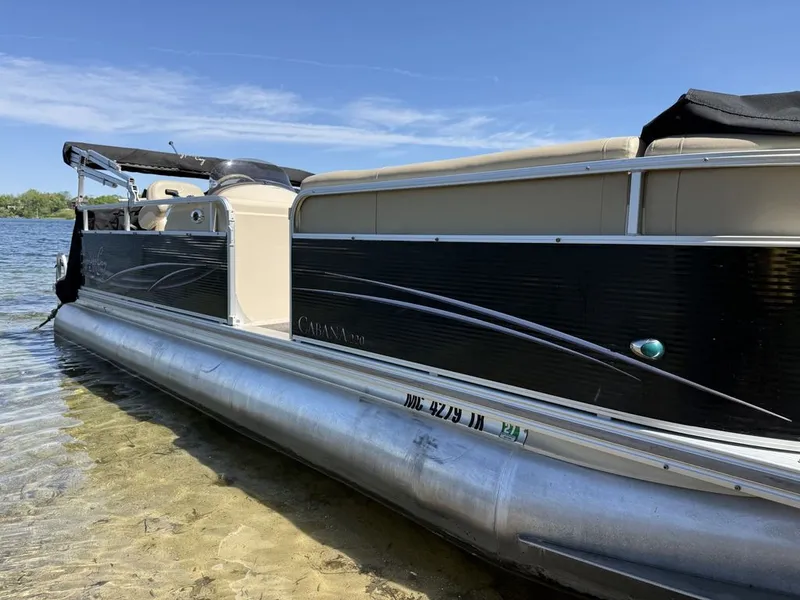 Slide: The Image of 2011 Cypress Cay 220 Cabana pontoon boat by the lakeside. - 2
