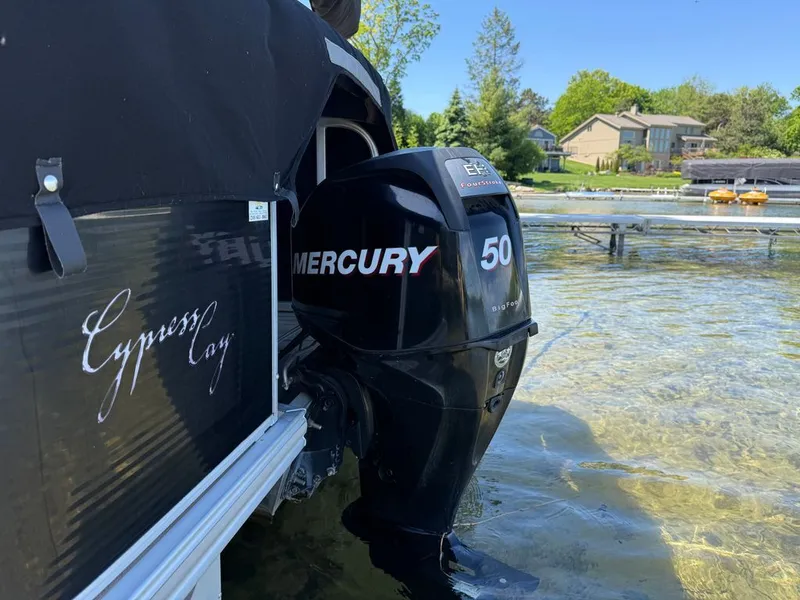 Slide: The Image of Cypress Cay 220 Cabana 2011 with Mercury 50 outboard motor by the lake. - 20