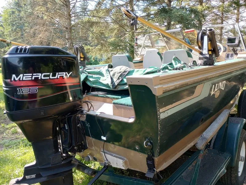 Slide: The Image of 1998 Lund 1900 Tyee boat with Mercury 125 outboard motor. - 3