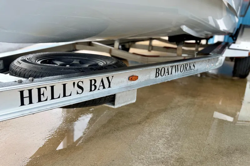 Slide: The Image of 2020 Hells Bay Professional boat trailer with visible tire and branding. - 11