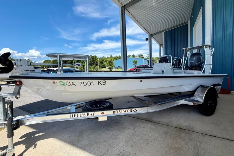 Slide: The Image of 2020 Hells Bay Professional boat on trailer, parked under a metal canopy. - 15