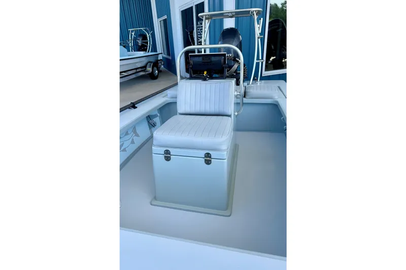 Slide: The Image of 2020 Hell's Bay Professional boat interior with cushioned Cooler seating and steering console. - 16