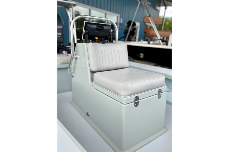 Slide: The Image of 2020 Hells Bay Professional boat console with cushioned seat in a showroom. - 4