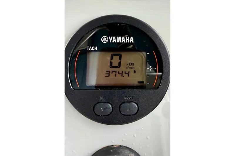 Slide: The Image of Yamaha tachometer displaying 374.4 hours on a 2020 Hells Bay Professional boat. - 7