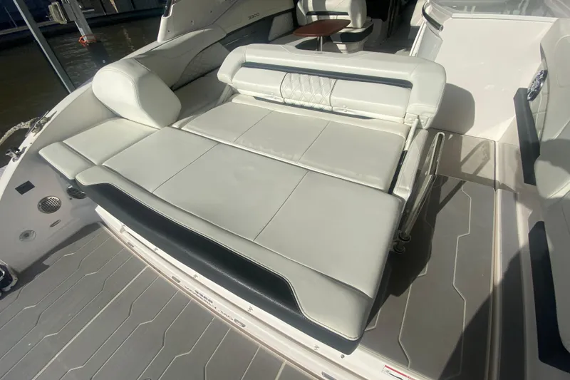 Slide: The Image of 2021 Regal 3300 Bowrider boat interior with luxurious white seating and sleek design. - 10