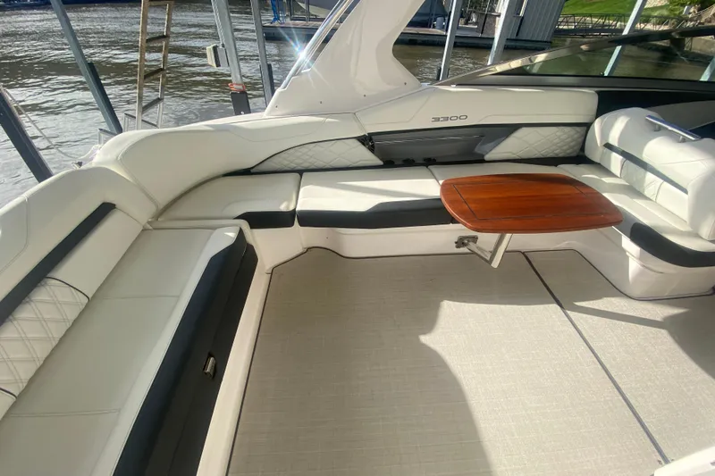 Slide: The Image of Luxurious 2021 Regal 3300 Bowrider interior with elegant seating and wooden table. - 11