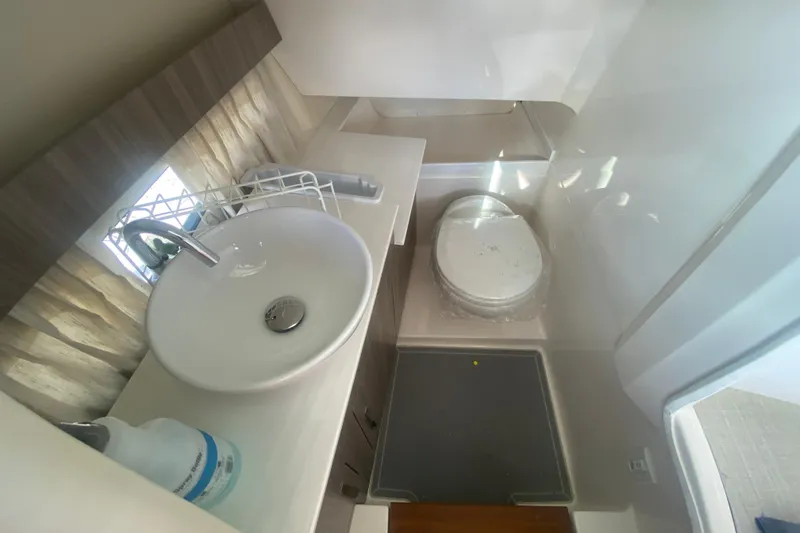 Slide: The Image of 2021 Regal 3300 Bowrider bathroom with modern sink and toilet. - 19