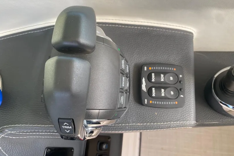 Slide: The Image of Throttle and control panel of a 2021 Regal 3300 Bowrider boat. - 23