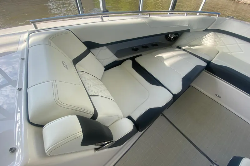 Slide: The Image of Luxurious seating on 2021 Regal 3300 Bowrider boat, featuring elegant white and black upholstery. - 29