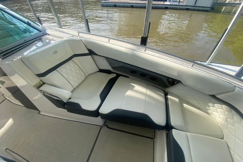 Slide: The Image of Luxurious seating on 2021 Regal 3300 Bowrider boat, docked by the water. - 31