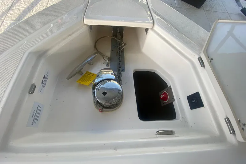 Slide: The Image of 2021 Regal 3300 Bowrider anchor compartment with winch and storage. - 33